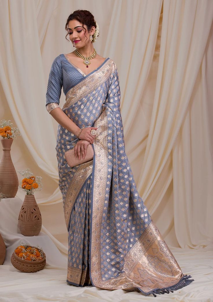 Model wearing a blue and gold saree.