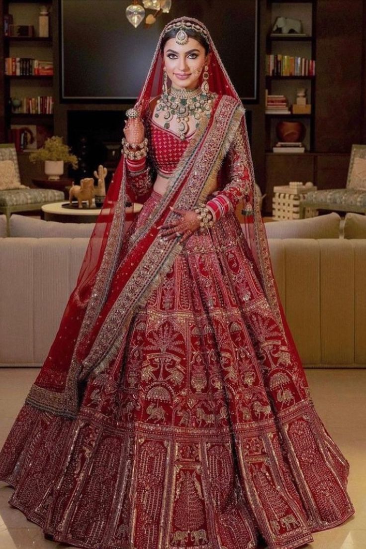 Bride wearing an ornate red bridal outfit.