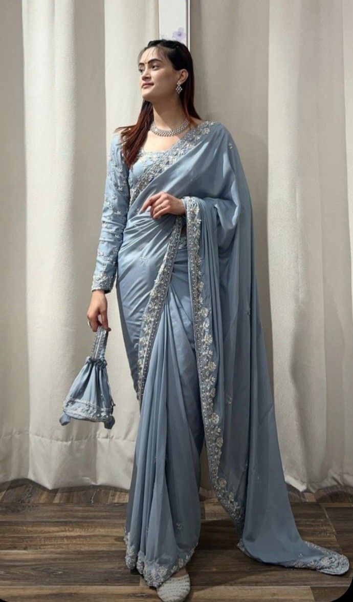 Model wearing a pale blue designer saree.