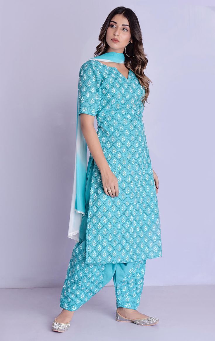 Model wearing a turquoise kurta and salwar set.