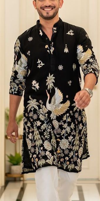Model wearing a black embroidered kurta.