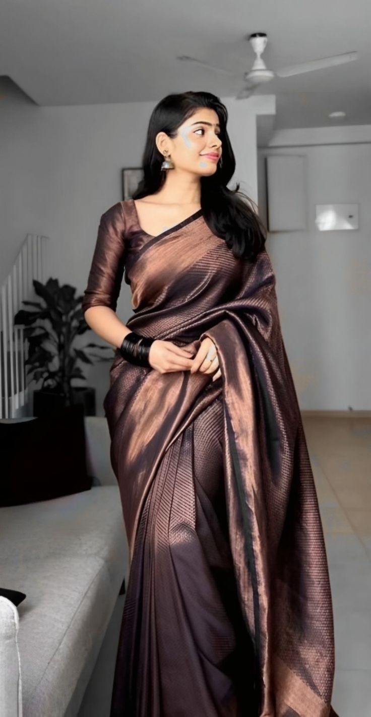 Model wearing a dark silk saree.