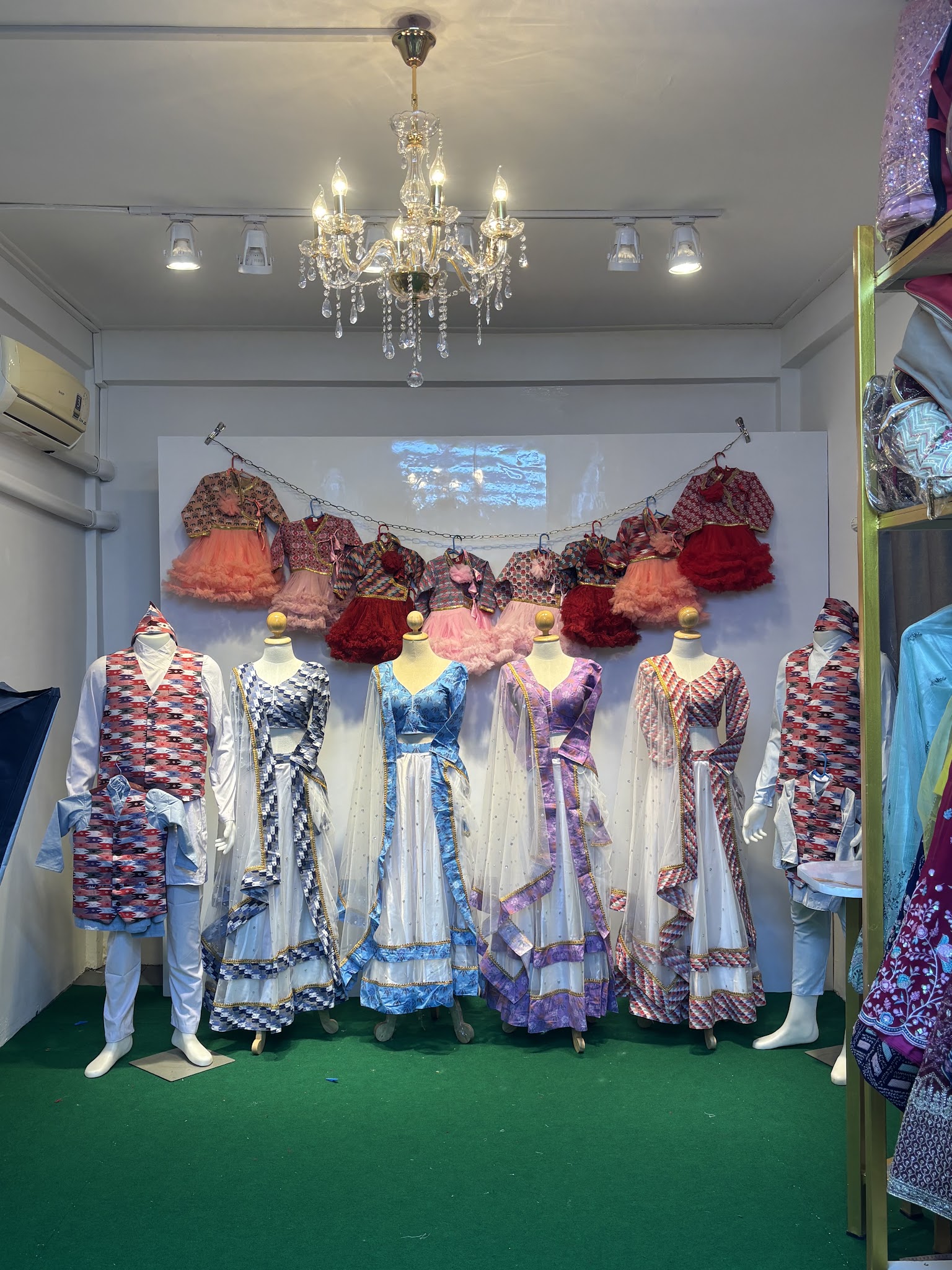 Mannequins in colorful traditional clothing inside the store.